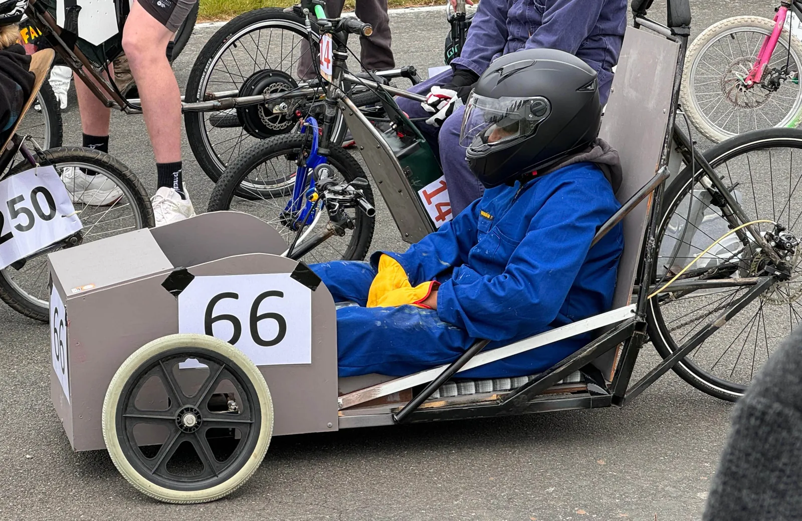 Vishan in a helmet and blue overalls in car number 66 on the start grid