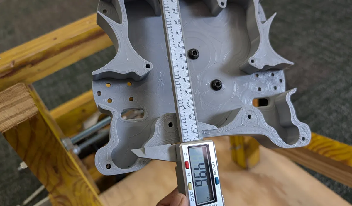 Printed steering wheel being measured with digital calipers