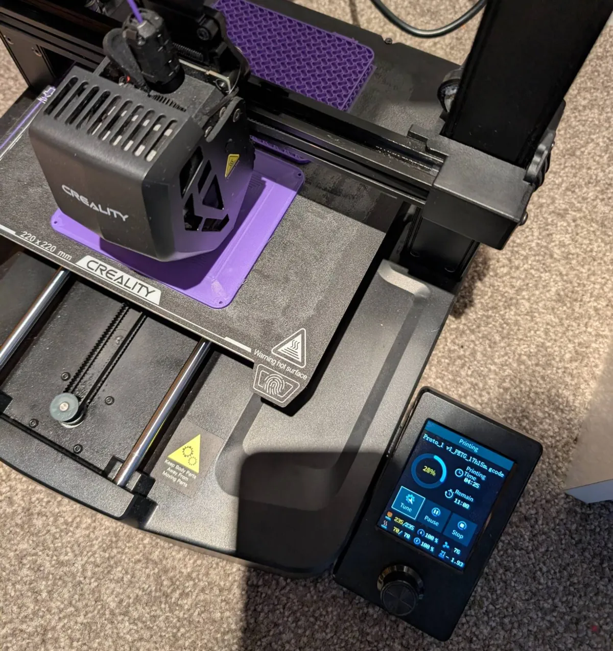 A purple enclosure being printed on a Creality printer, with the screen reading Proto_1 v1 PETG