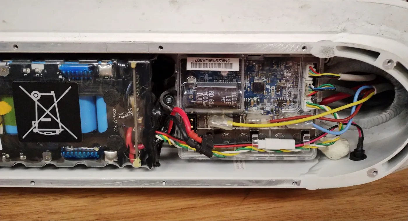 The scooter’s deck opened up, showing the battery pack, the controller board and the wiring