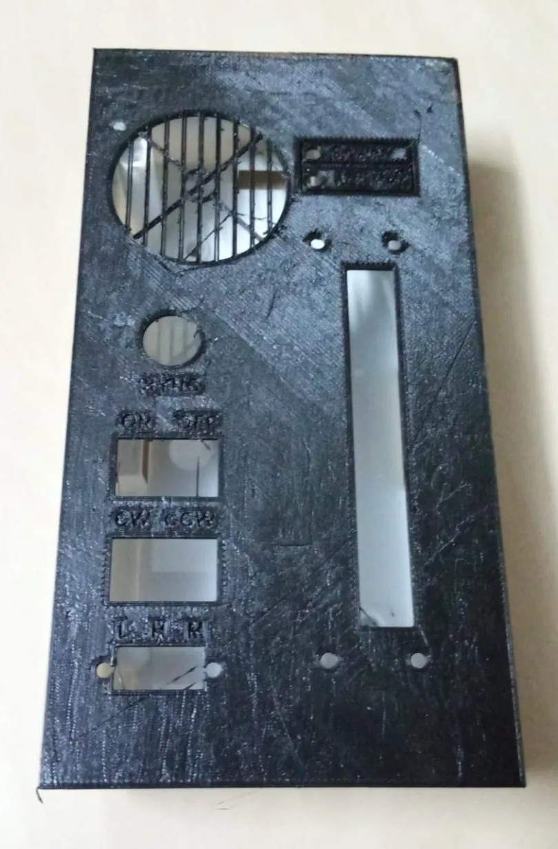 The printed lid with the fan grille, the slider slot and labelled switch cutouts